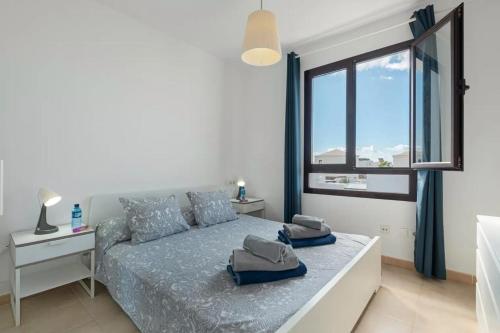 Un dormitorio con una cama y una ventana grande. en Luxury Villa Lanzarote, en Playa Blanca