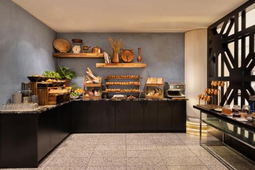 a shop with a counter with a lot of food at Pullman Auckland Hotel & Apartments in Auckland