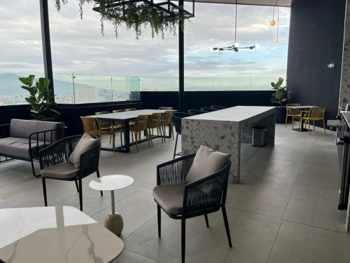 a restaurant with tables and chairs and a view at Chic Studio in Barrio Escalante in Tapantí