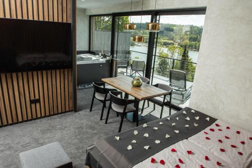 a bedroom with a table and chairs and a bed at Hotel Kras in Jedovnice