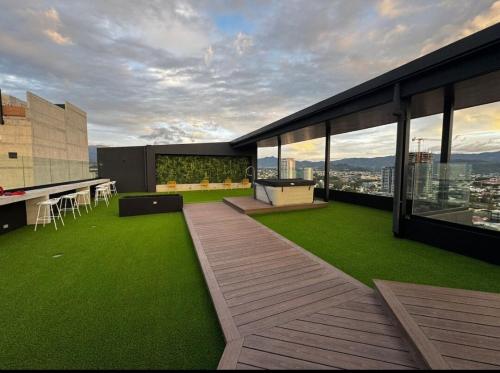 an outdoor patio with green grass on a building at Chic Studio in Barrio Escalante in Tapantí