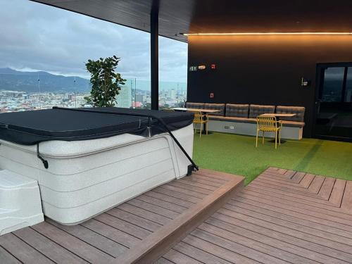 a room with a ping pong table on a deck at Chic Studio in Barrio Escalante in Tapantí
