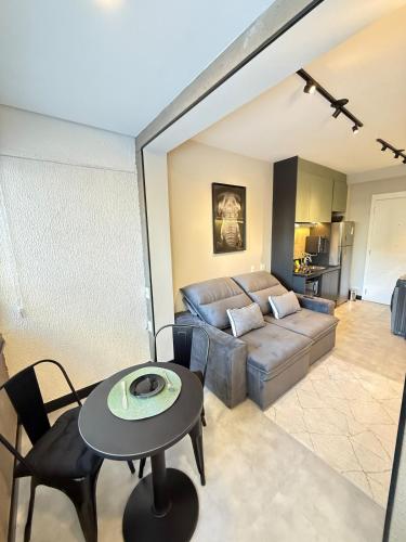 a living room with a couch and a table at House Mitre in Sao Paulo