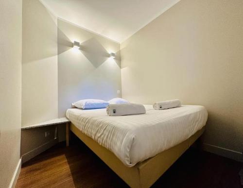 une chambre avec un lit avec deux oreillers dessus dans l'établissement Vue Mer, Piscine de ouf Votre Oasis à Cannes, à Cannes