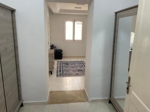 a hallway of a home with a door and a tile floor at Maison attia in Bin Rhilouf