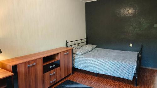 a small bedroom with a bed and a dresser at Seebi-apartment in Tallinn
