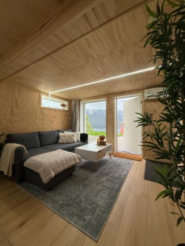 a living room with a couch and a table at The View of the Senja mountains in Senja