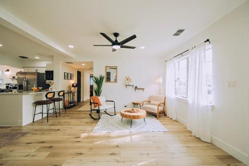 a living room with a ceiling fan and a table at Oasis Over the Bridge of Lions in Saint Augustine