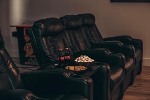 a leather chair with a table with drinks and popcorn at Oasis Over the Bridge of Lions in Saint Augustine