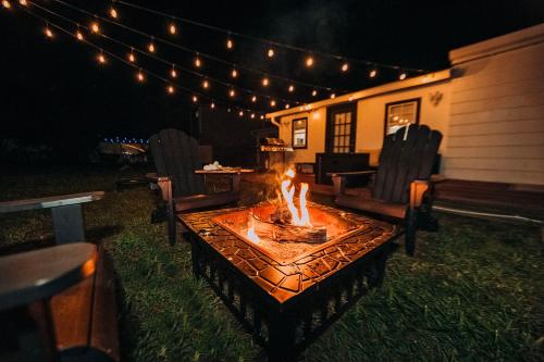 a fire pit in the yard at night with lights at Oasis Over the Bridge of Lions in Saint Augustine