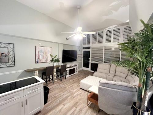 a living room with a couch and a table at First floor direct beach access in Daytona Beach