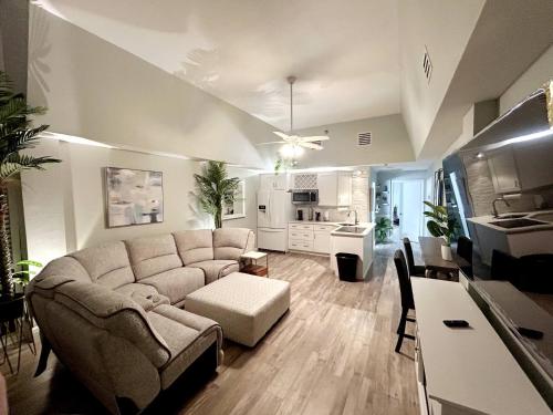 a living room with a couch and a kitchen at First floor direct beach access in Daytona Beach