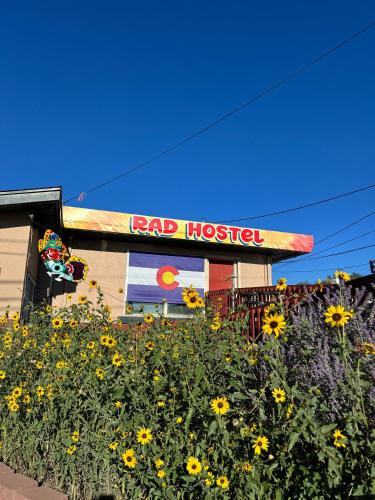 a fast food restaurant with a field of yellow flowers at RAD Hostel in Colorado Springs