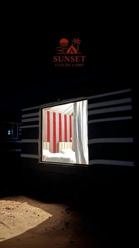 a window in a building with a sign on it at Sun Set Luxury Camp in Disah