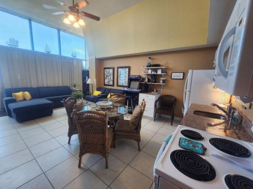 a kitchen and living room with a table and a couch at Daytona Beach 1 bdrm Oceanfront Luxury Condo in Daytona Beach