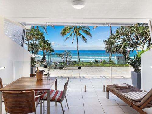 a dining room with a table and a view of the ocean at Fairshore in Noosa Heads
