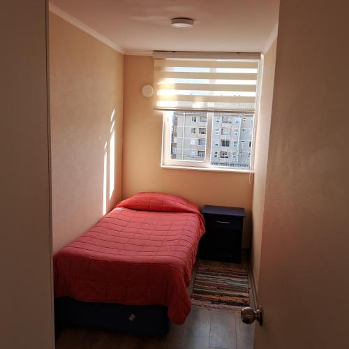 Кровать или кровати в номере Acogedor departamento con estacionamiento