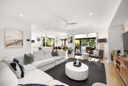 a living room with a white couch and a table at Golden Beach Luxury for Families in Golden Beach