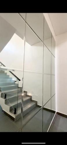 a glass wall with stairs in a room at 3bedroom maisonette Banana, Ikoyi in Ikoyi