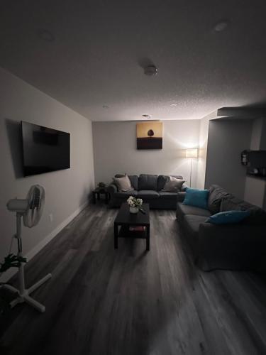 a living room with a couch and a table at Elegant Cozy Private Apartment in Calgary