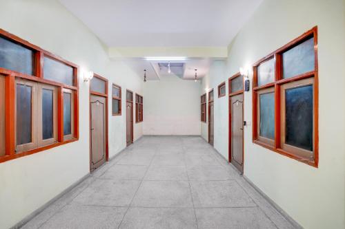 a corridor of an empty room with windows at Super Hotel O The Comfort in Kānpur