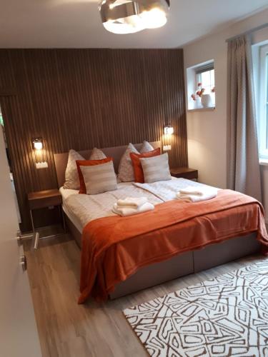 a bedroom with a bed with two towels on it at Schafberg Luxury Apartment in St. Wolfgang