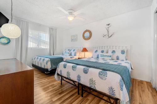 a bedroom with two beds and a ceiling fan at Pineapple Republic in Anona