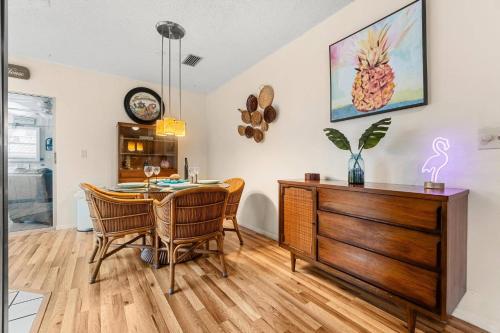 a dining room with a table and chairs and a dresser at Pineapple Republic in Anona