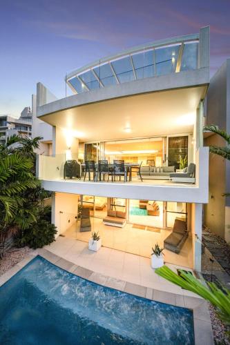 an exterior view of a house with a swimming pool at Absolute Beachfront Marcoola - Private Pool - Private Spa Bath - Games in Marcoola