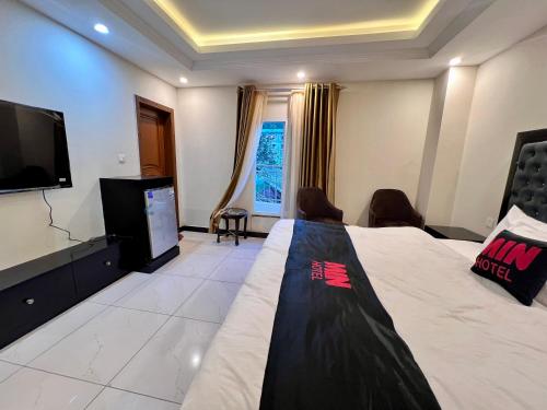 a hotel room with a bed and a flat screen tv at Mehboob international hotel murree in Murree