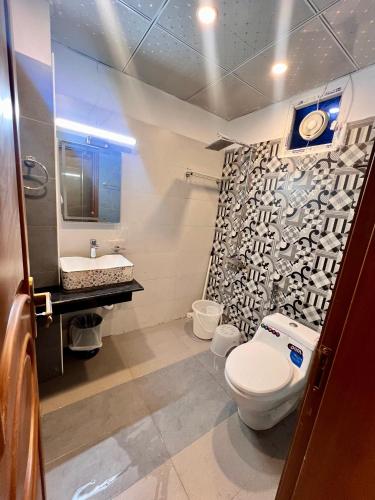 a bathroom with a toilet and a sink at Mehboob international hotel murree in Murree