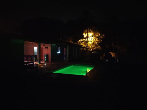 a pool in the middle of a yard at night at Chácara - Recanto dos Sonhos -CMC - IBIUNA in Ibiúna