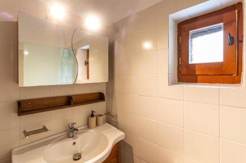 a bathroom with a sink and a mirror at Hillside View, House 1 in Stoupa