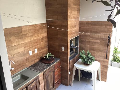 a kitchen with wooden walls and a sink and a table at CASA AMPLA para COP 30 - Ótima localização! in Belém