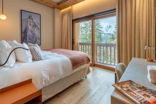 Giường trong phòng chung tại Antarès Méribel Luxury Apartment