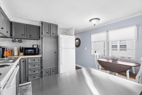 a kitchen with a white refrigerator and a table at Peaceful Nokomis Escape 5 Mins to Beach 55 in Nokomis