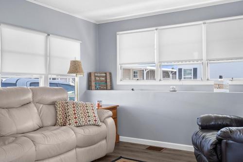 a living room with a couch and two windows at Peaceful Nokomis Escape 5 Mins to Beach 55 in Nokomis