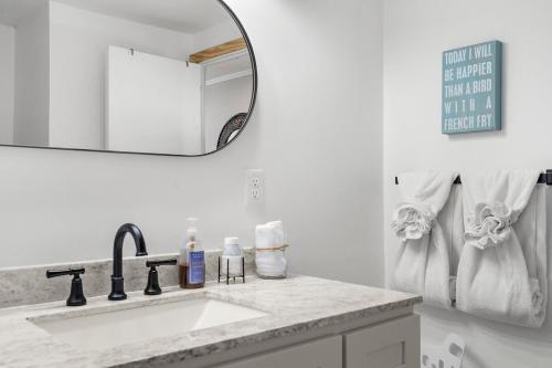 a white bathroom with a sink and a mirror at Peaceful Nokomis Escape 5 Mins to Beach 55 in Nokomis