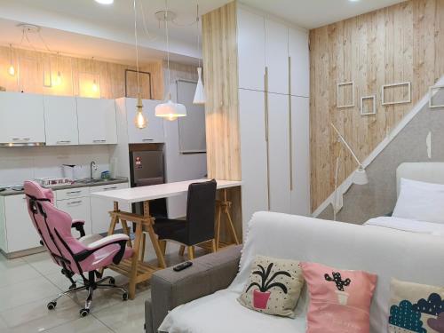 a kitchen and living room with a couch and a table at Peace home apex in Cyberjaya
