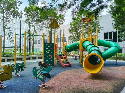 a playground with a green and yellow slide at Peace home apex in Cyberjaya