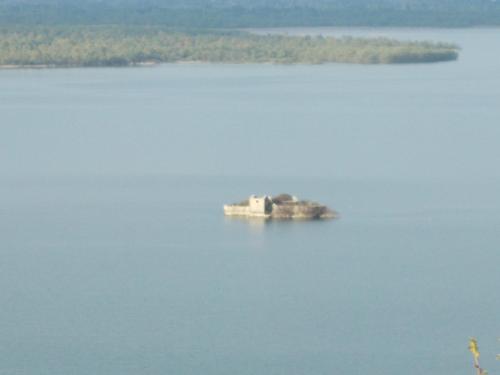 an island in the middle of a large body of water at Guesthouse Feel Lake in Virpazar