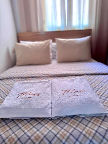 a bed with two towels on top of it at joli appart avec terrasse au centre ville in Tetouan