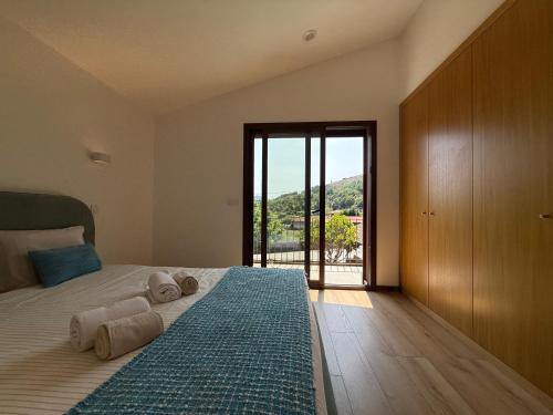 a bedroom with a bed with towels on it at Casa da Fonte - Gerês in Terras de Bouro