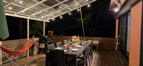 a table and chairs on a patio at night at TigerHouse in Nasu