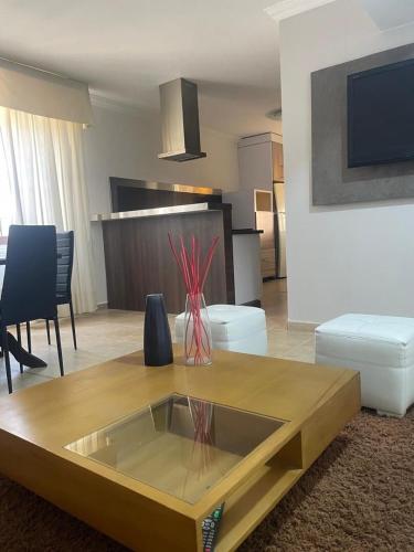 a living room with a couch and a table at Apartamento moderno y economico in Mérida