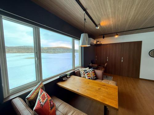 a living room with a table and large windows at FLEXWORK tawa - Vacation STAY 99885v in Teshikaga
