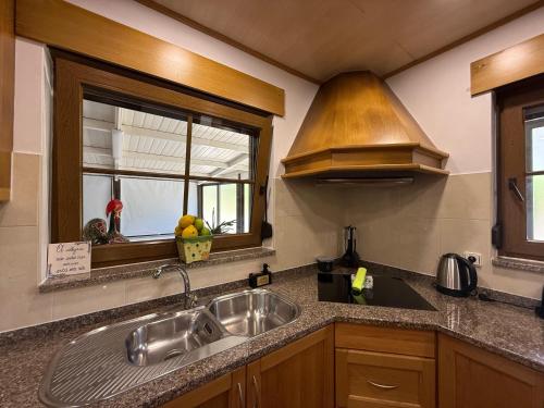 a kitchen with a sink and a window at Casa Terra Nova - Gerês in Terras de Bouro