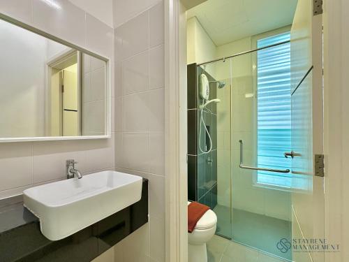 a bathroom with a sink and a glass shower at Holi 1Medini Themed Suites in Nusajaya