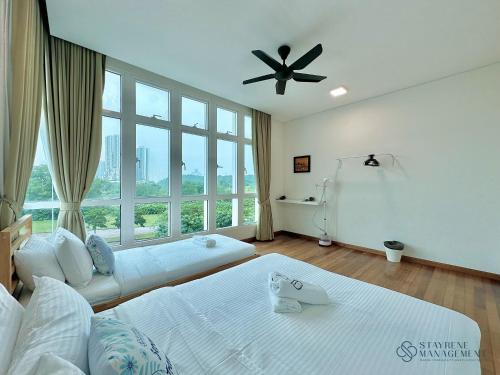a bedroom with two beds and a ceiling fan at Holi 1Medini Themed Suites in Nusajaya