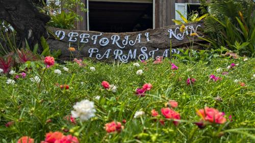 a sign in the middle of a field of flowers at DeeTorJai FarmStay Nan ดีต่อใจ ฟาร์มสเตย์ น่าน โดยเจ้าของ in Ban Klang